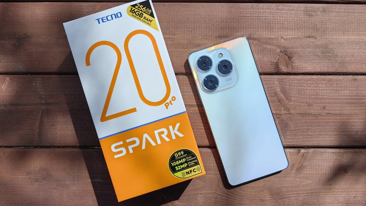 TECNO Spark 20 Pro with packaging on a wooden surface in natural light.